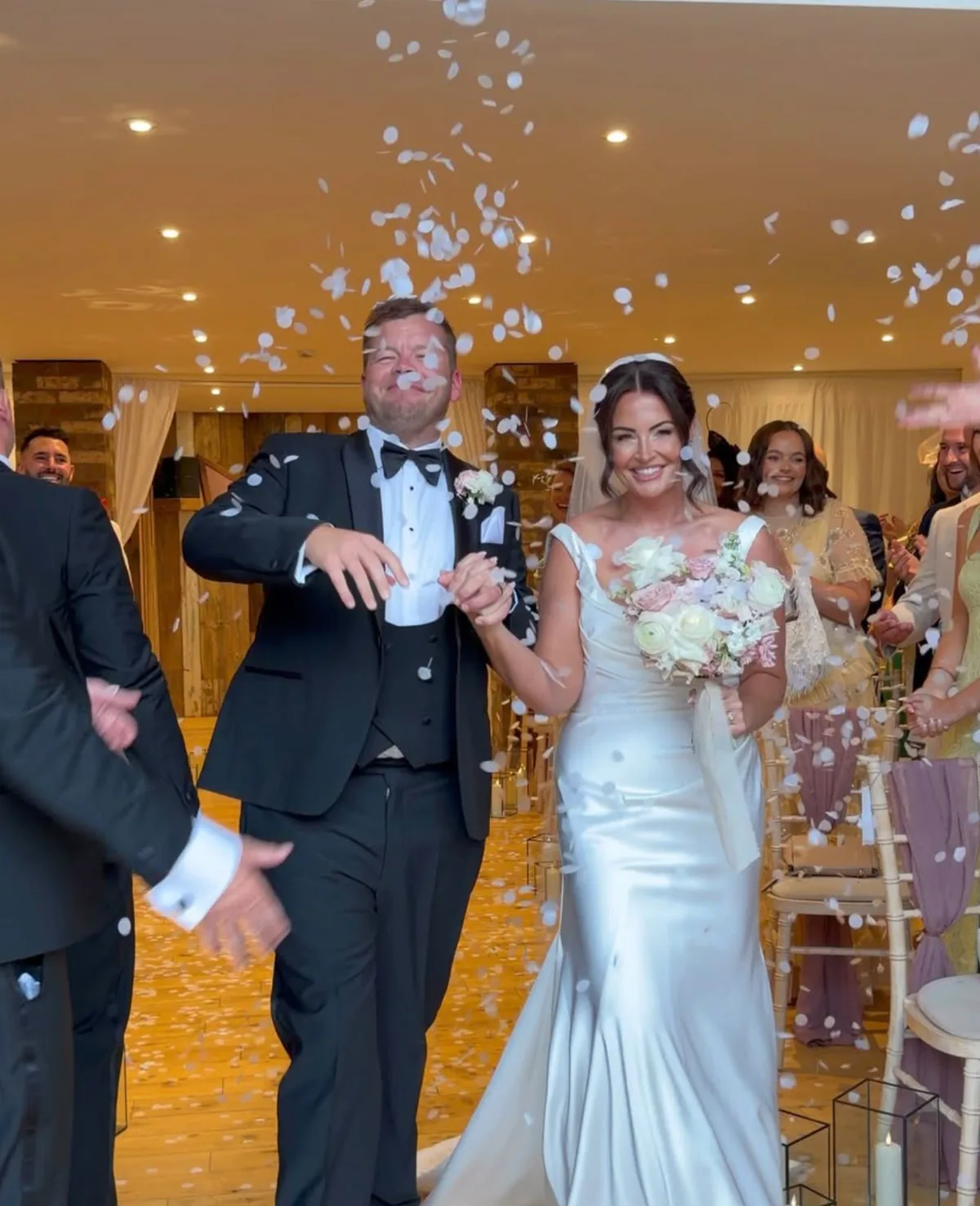 Jamie and Lucy back up the aisle through the confetti at Bunny Hill Weddings