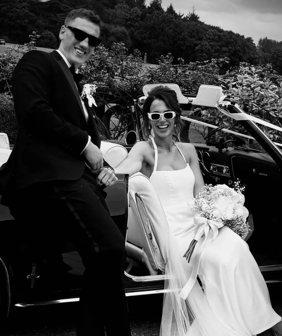 Jack and Amber at Capesthorne Hall, beside their wedding car