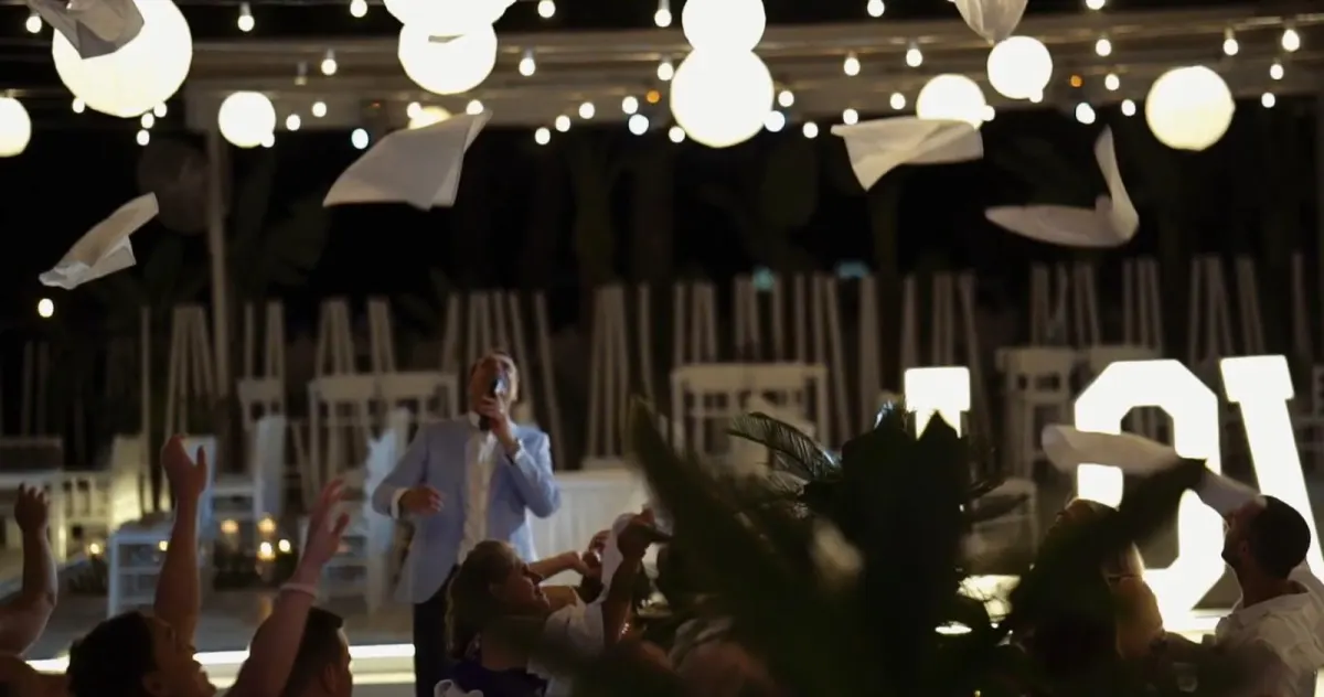 Napkins in the air as Howard sings, a Cyprus wedding at night