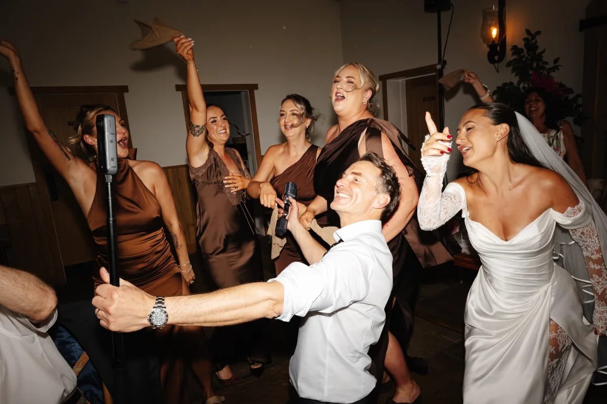 Leah and her bridesmaids on the dance floor at Hobbit Hill, Howard in the middle