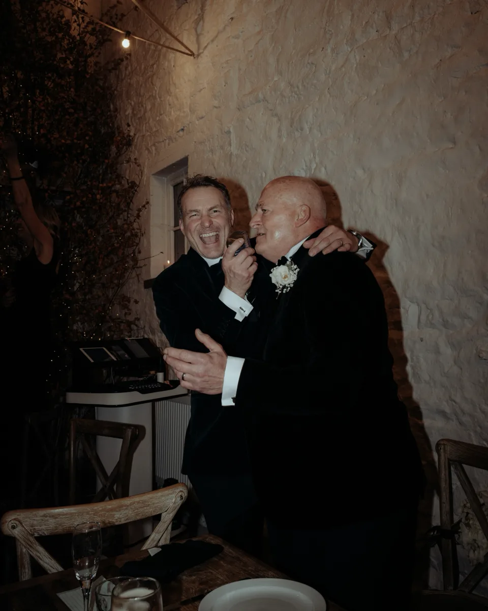 Howard Wing laughing with a groom mid-set