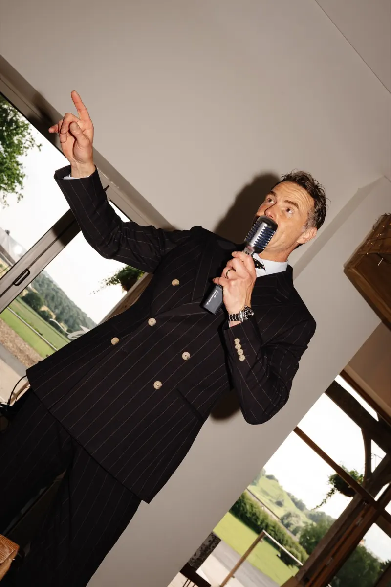 Howard Wing performing in his navy pinstripe suit at a Lancashire wedding